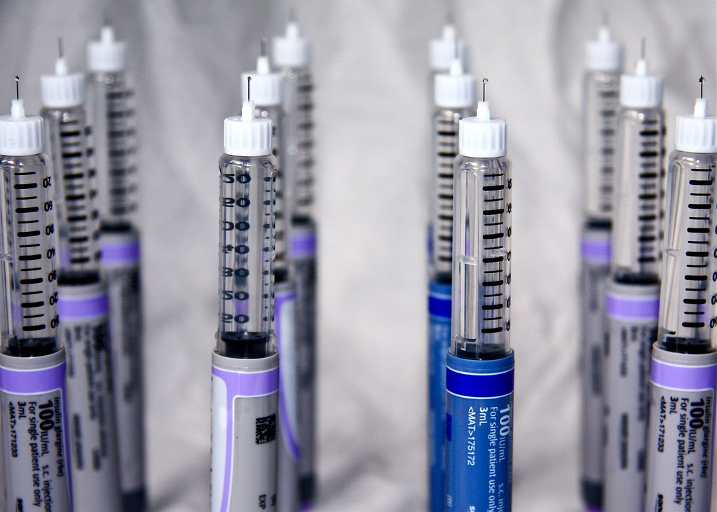 A row of prepared single-use syringes
