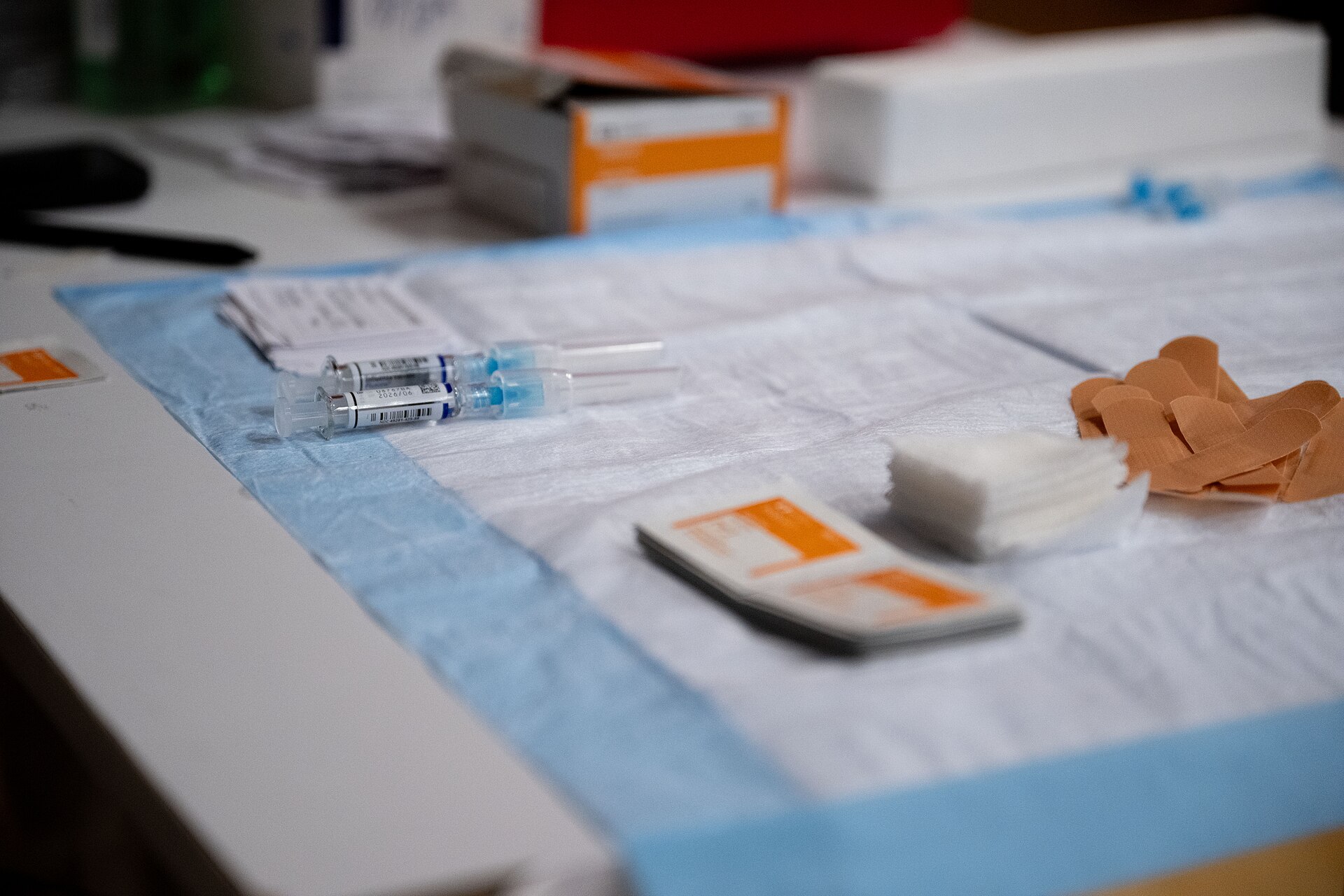 Prepared syringes and swabs on a sterile vaccination tray