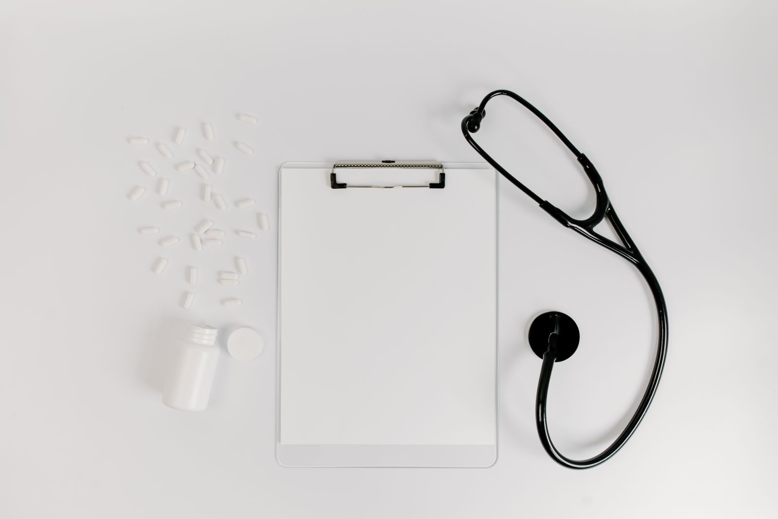 Clipboard, stethoscope and medication for a medical consultation