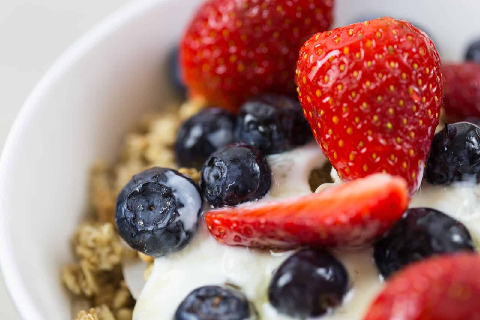 Yogurt bowl with granola, strawberries and blueberries