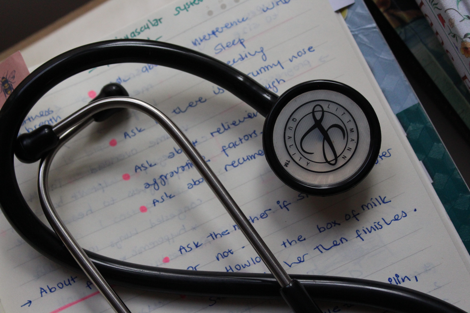 Stethoscope resting on handwritten medical notes