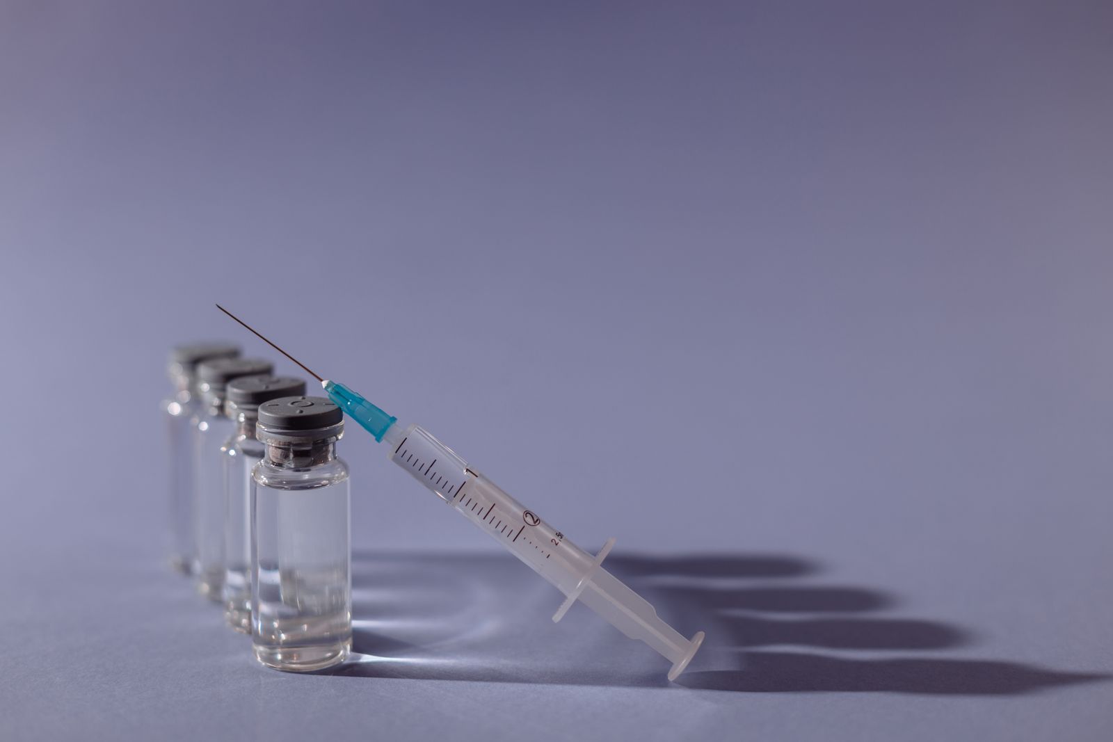 Vaccine vials with a syringe