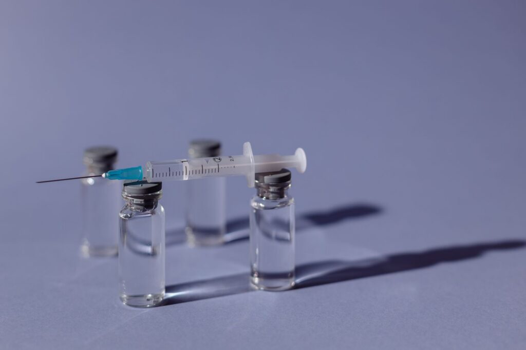 Vaccine vials with a syringe
